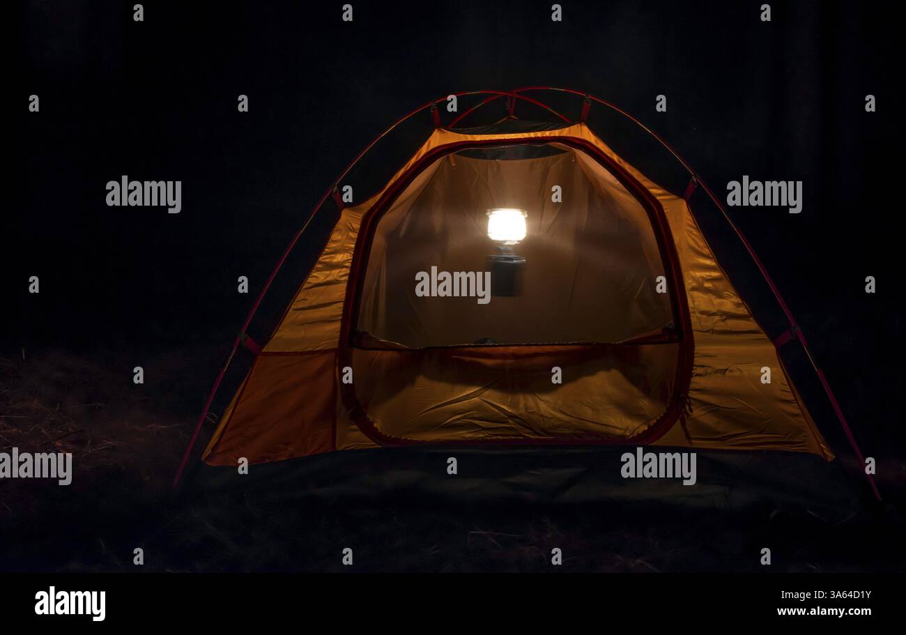 Orange tent in the forest at night Stock Photo - Alamy