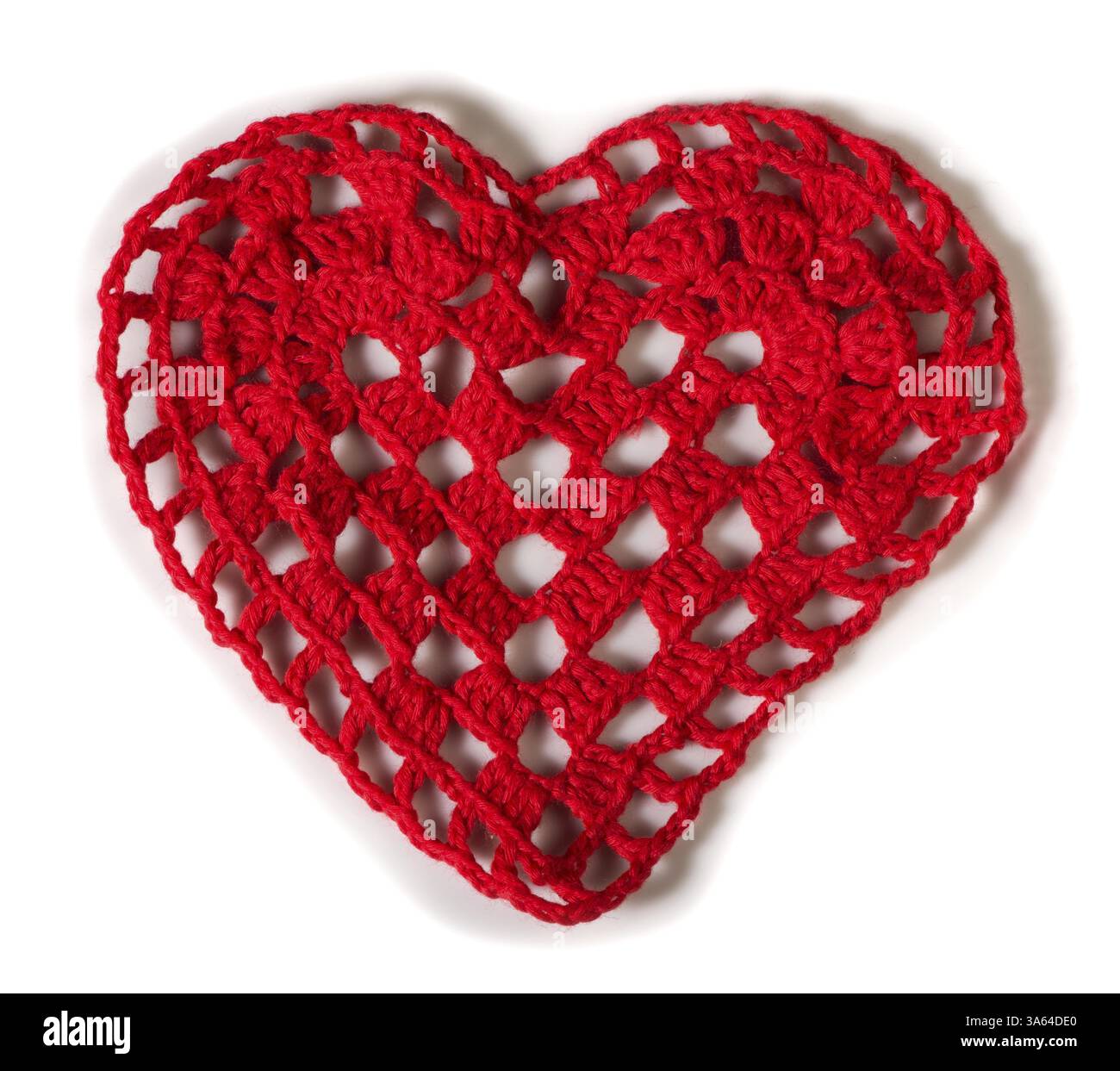 Knitted red heart made of yarn. White isolated Stock Photo - Alamy