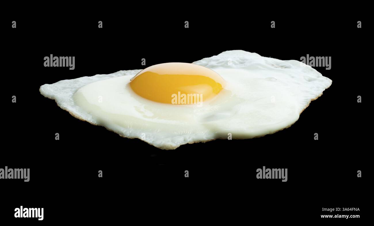 Fried egg on black background Stock Photo