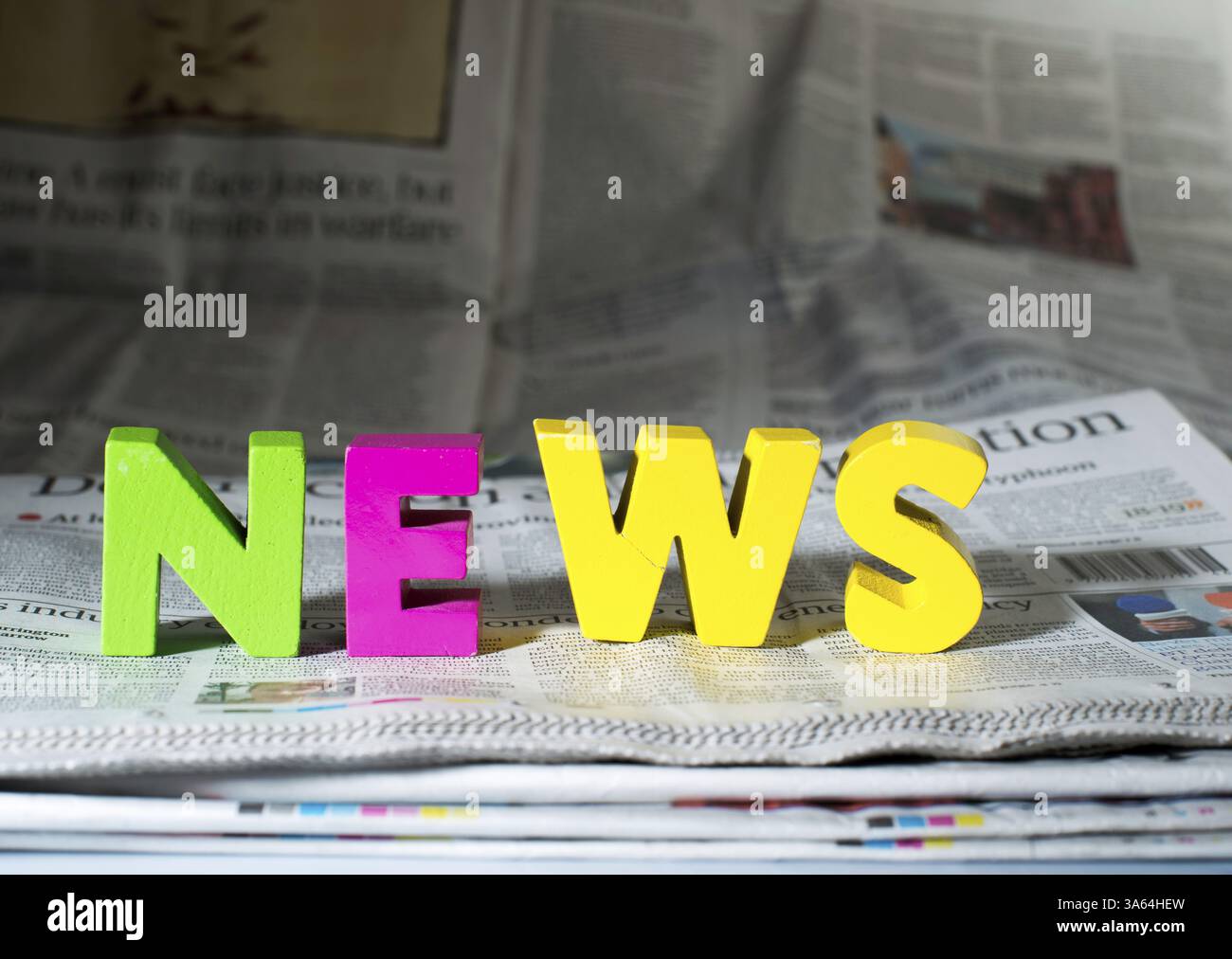 Word news on newspaper. Wooden letters Stock Photo