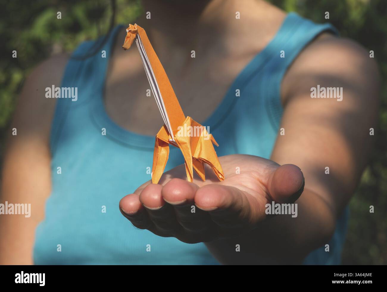 Origami orange color giraffe on hand Stock Photo