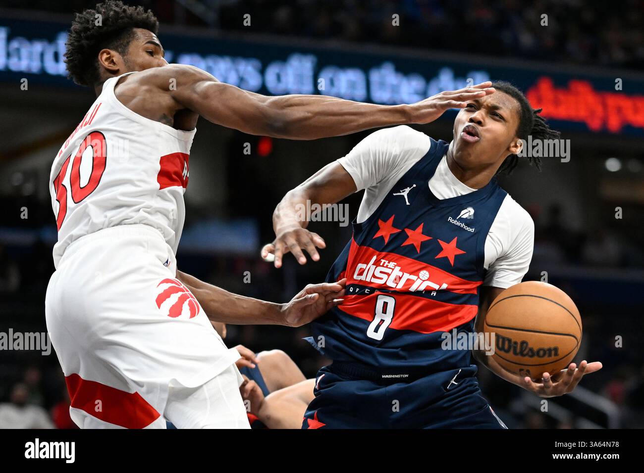 Toronto Raptors guard Ochai Agbaji, left, blocks Washington Wizards ...