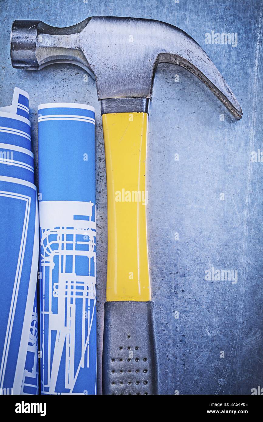 Composition of blue engineering drawings claw hammer on metallic ...