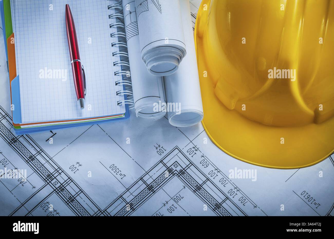 Protective building helmet checked notebook pen blueprints on construction plan Stock Photo