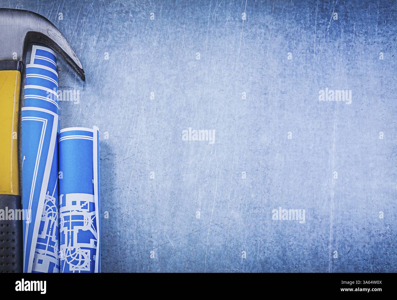 Blue rolled blueprints claw hammer on metallic background copyspace ...