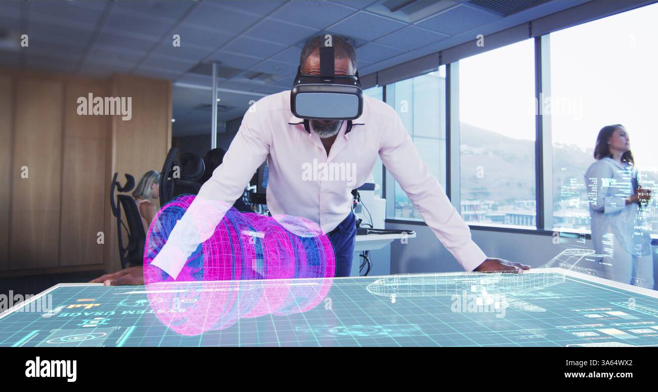 Man using VR headset interacting with holographic display in modern office Stock Photo