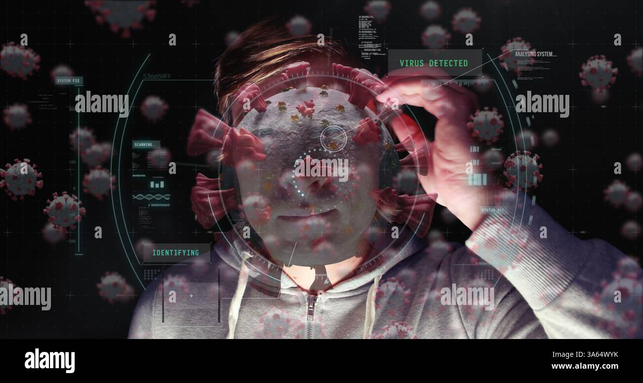 Analyzing virus data on digital interface, man in hoodie with focused expression Stock Photo