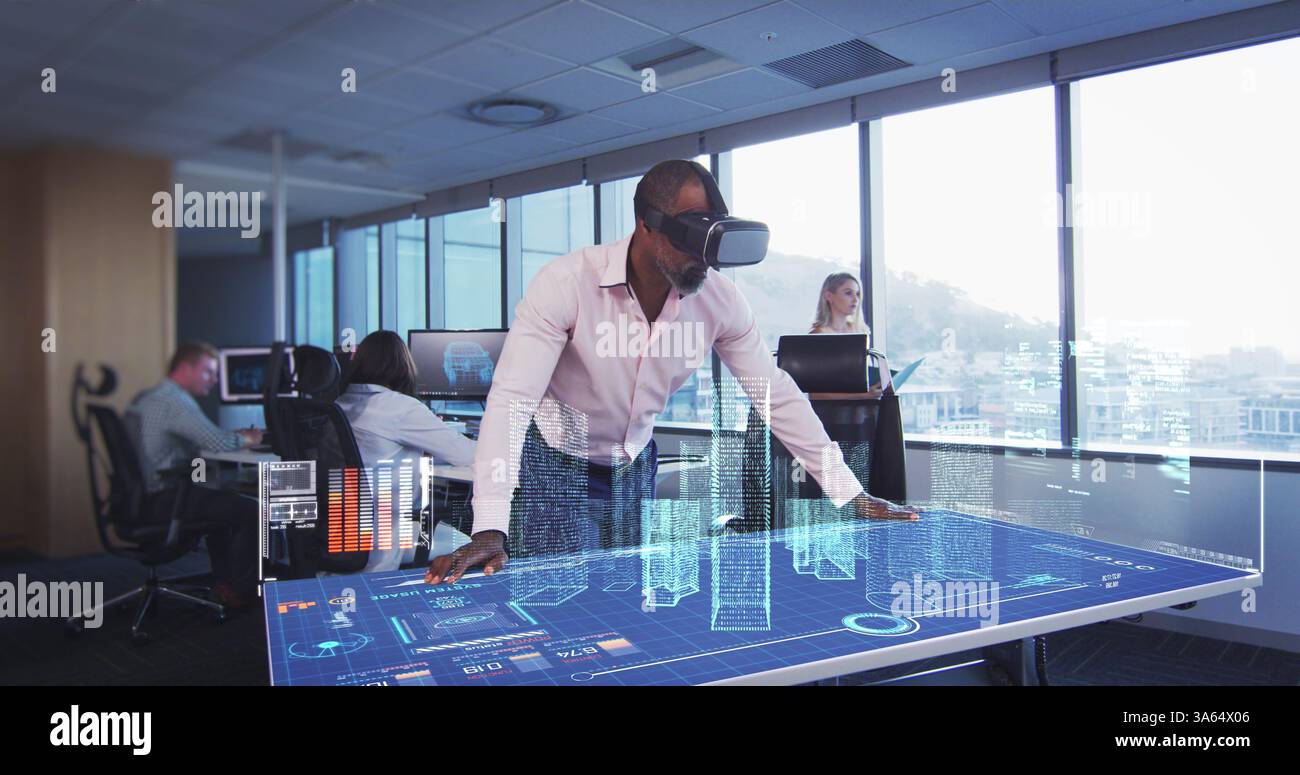 In modern office, man using VR headset interacting with futuristic digital table Stock Photo