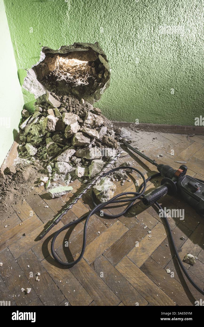 Drilling a big hole in the wall. Drill Stock Photo