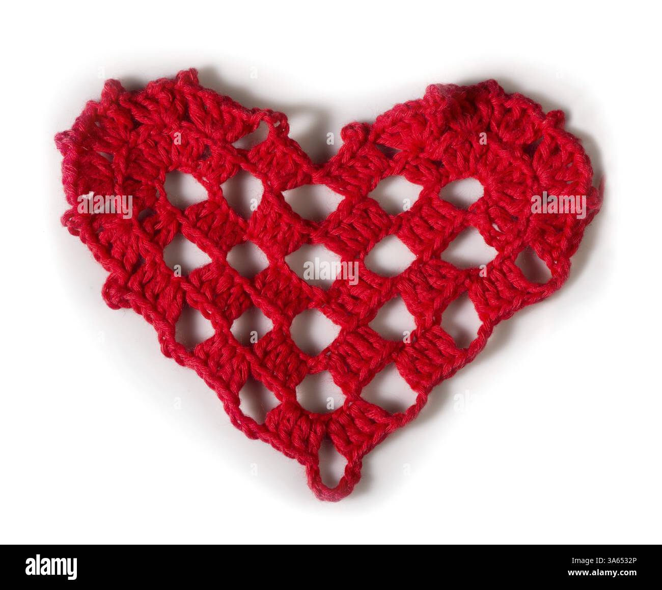 Knitted red heart made of yarn. White isolated Stock Photo - Alamy