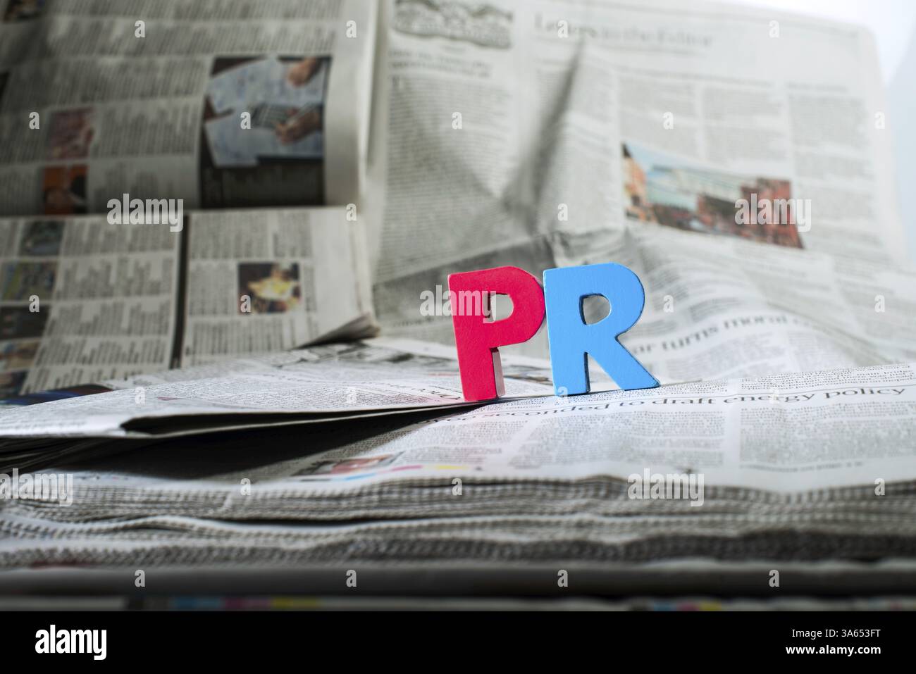 Word PR on newspaper. Wooden letters Stock Photo