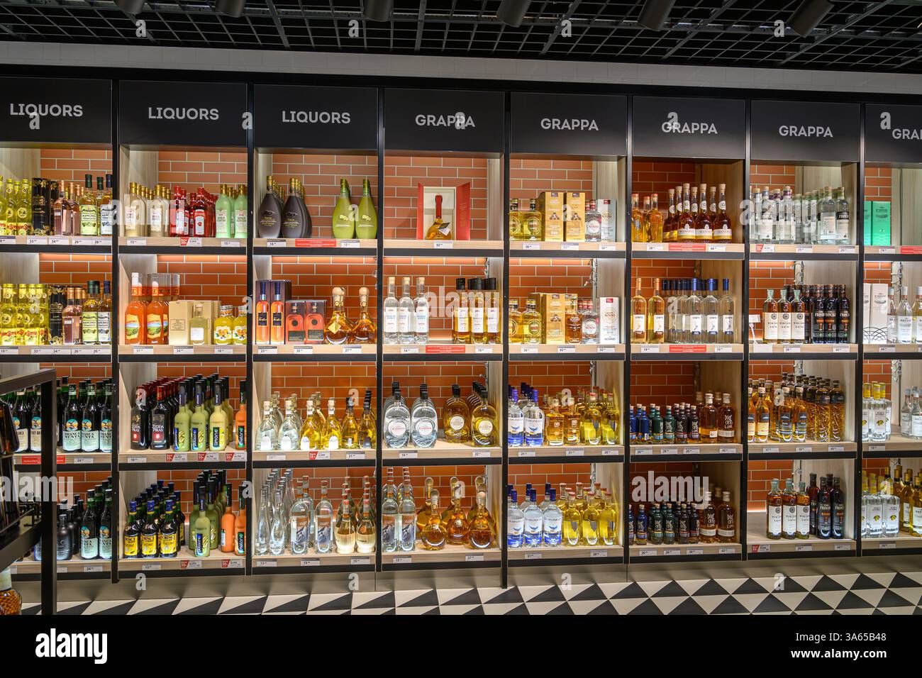 Grappa alcohol (Pomace brandy) bottles on shelves inside a shop Milan, Italy 06 March 2025