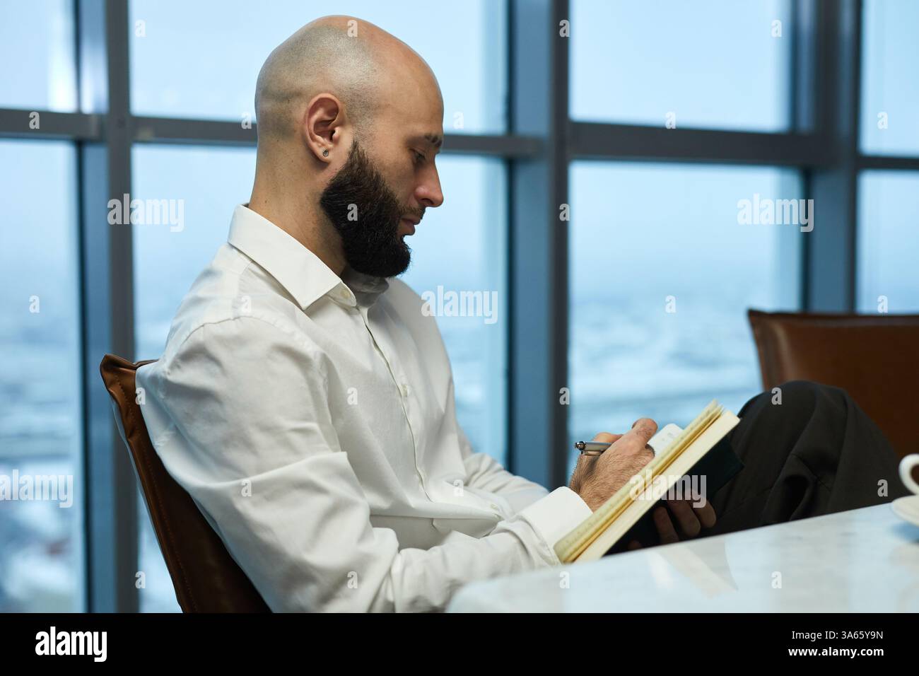Businessman Making Notes In Notebook Stock Photo