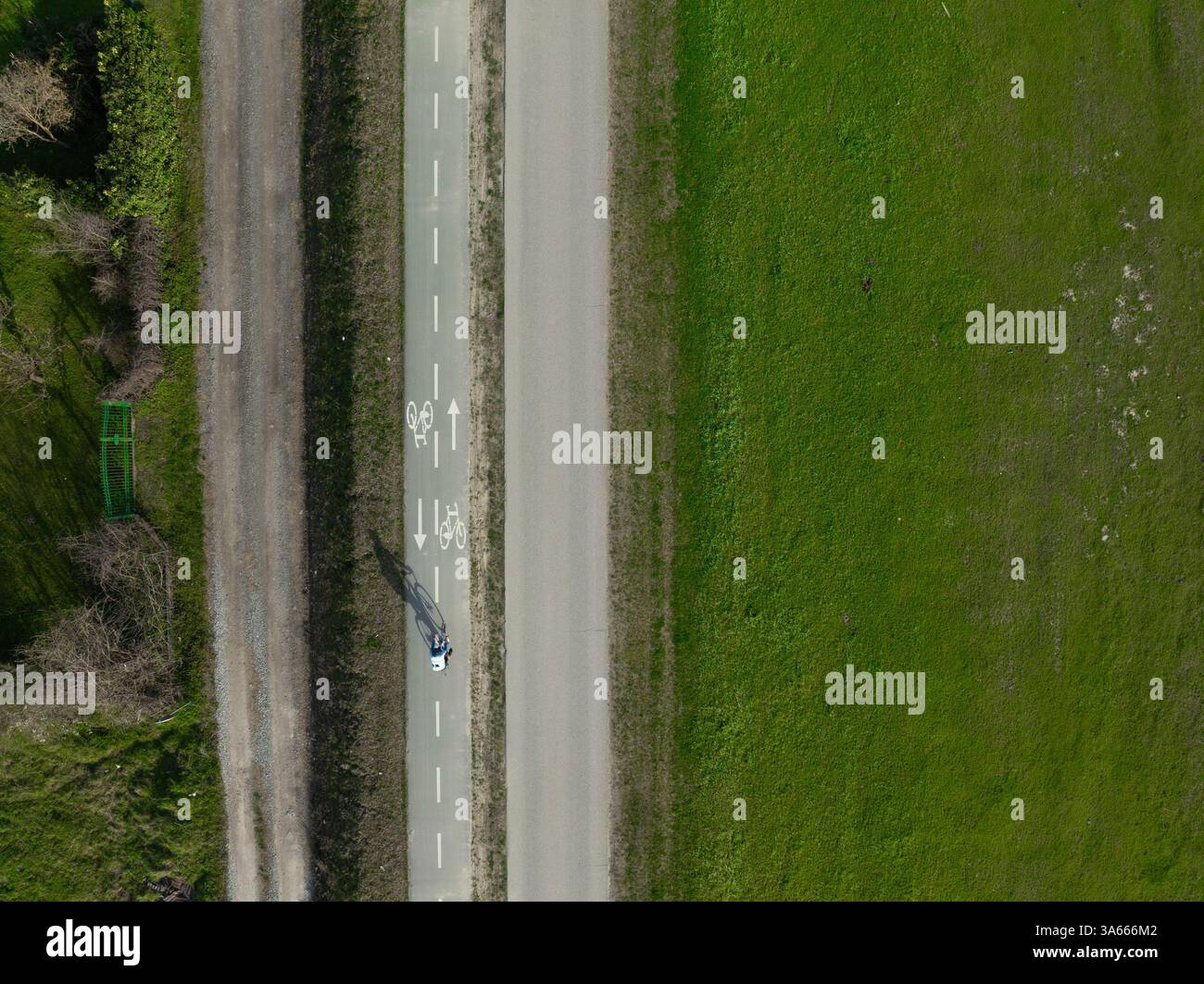 Aerial top down photo of a single cyclist exercising on a summer day ...