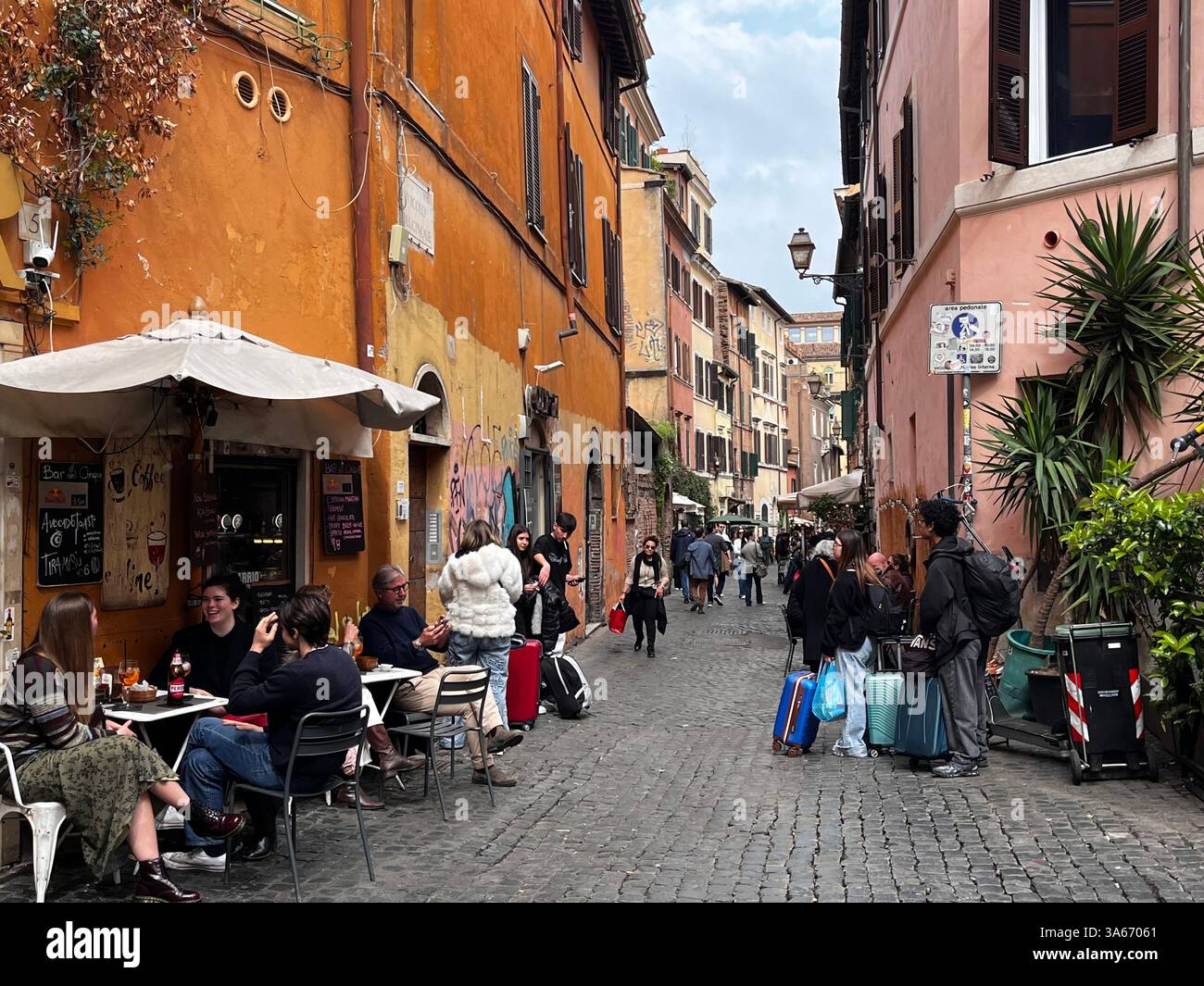 Rome, Italy - March 2025 - Trastevere District,  narrow cobbled streets lined by ancient houses. At night, natives and tourists alike flock to its man Stock Photo