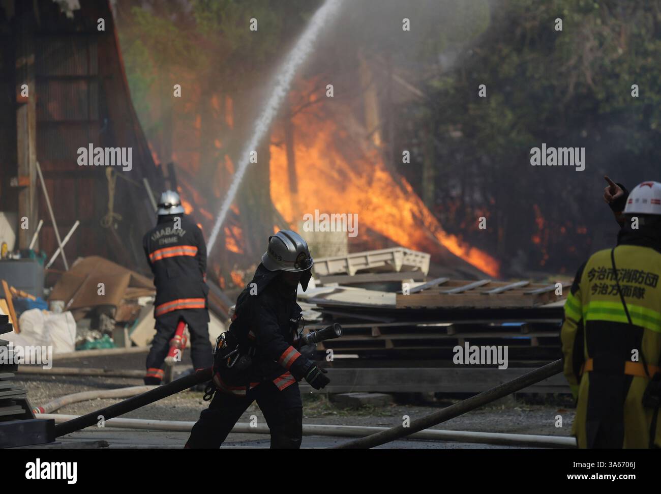 Firefighters struggle to extinguish the fire triggered by a wildfire in ...