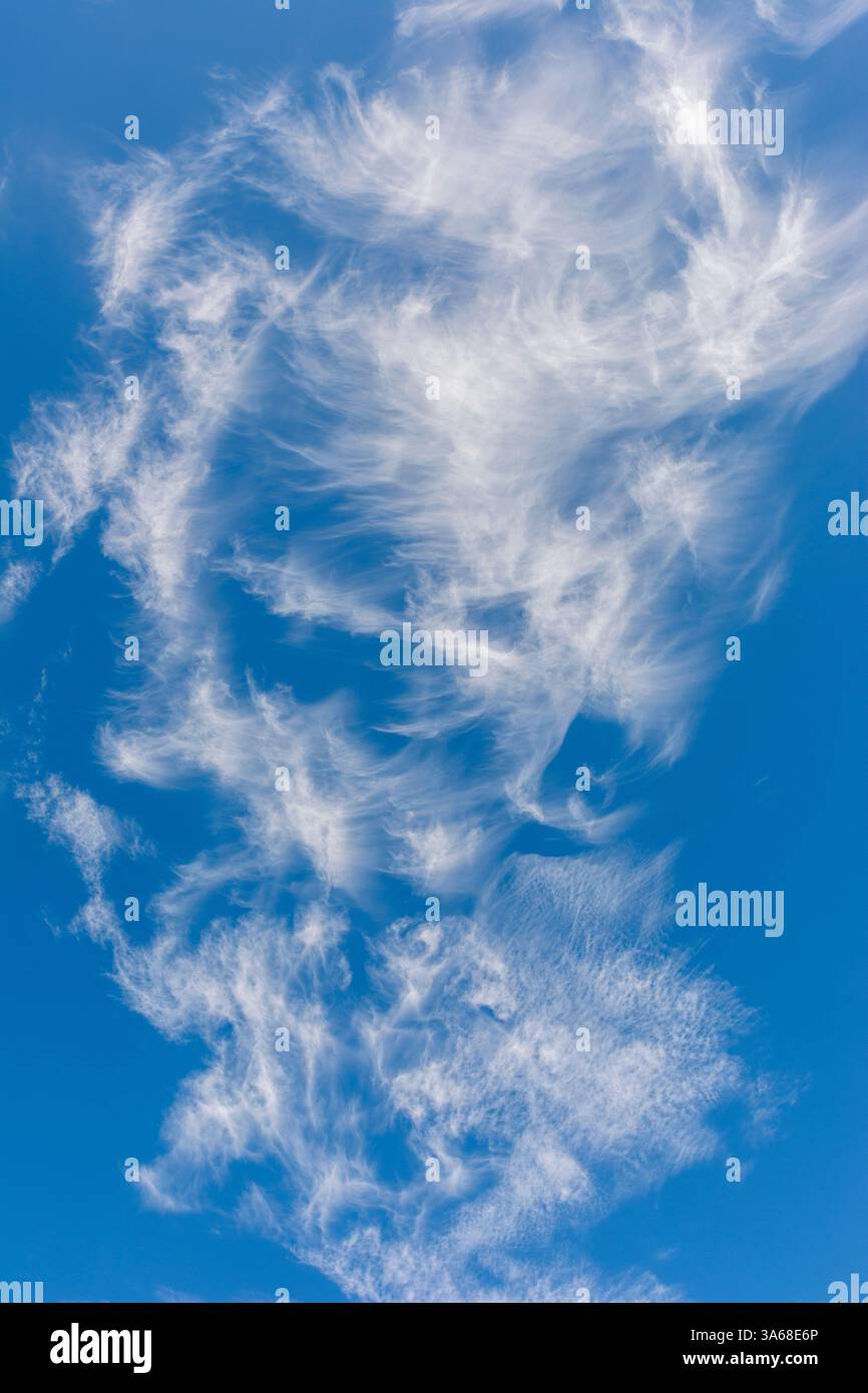 Wispy white cirrus clouds in blue sky Stock Photo - Alamy