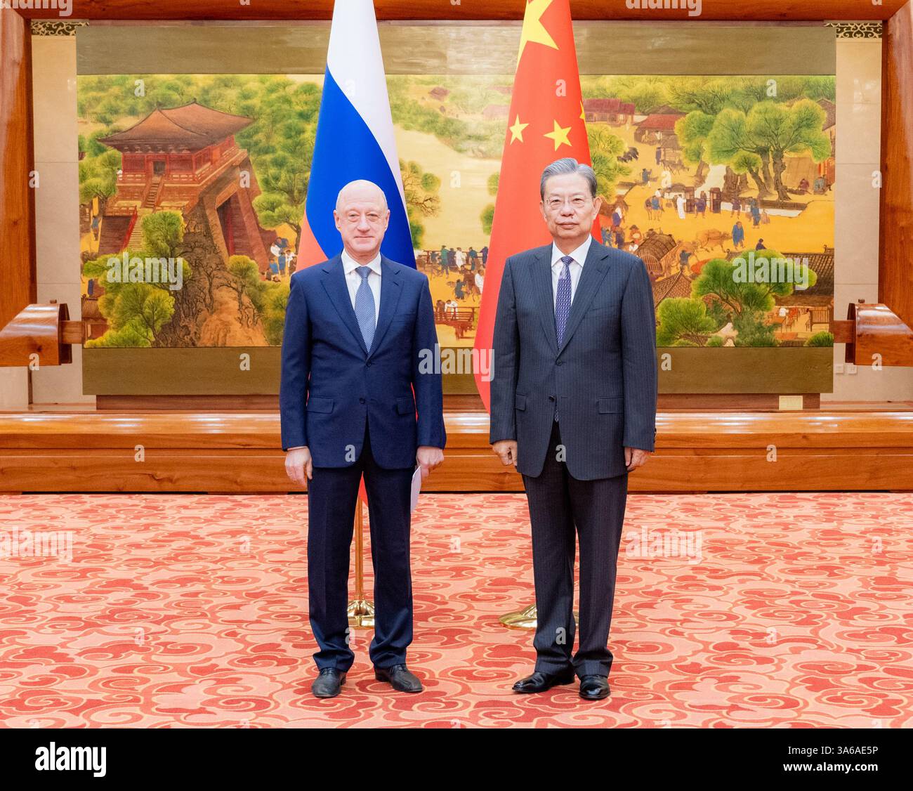 Beijing, China. 25th Mar, 2025. Zhao Leji, chairman of the National People's Congress Standing Committee, meets with Deputy Chairman of the Russian State Duma Alexander Babakov in Beijing, capital of China, March 25, 2025. Credit: Zhai Jianlan/Xinhua/Alamy Live News Stock Photo