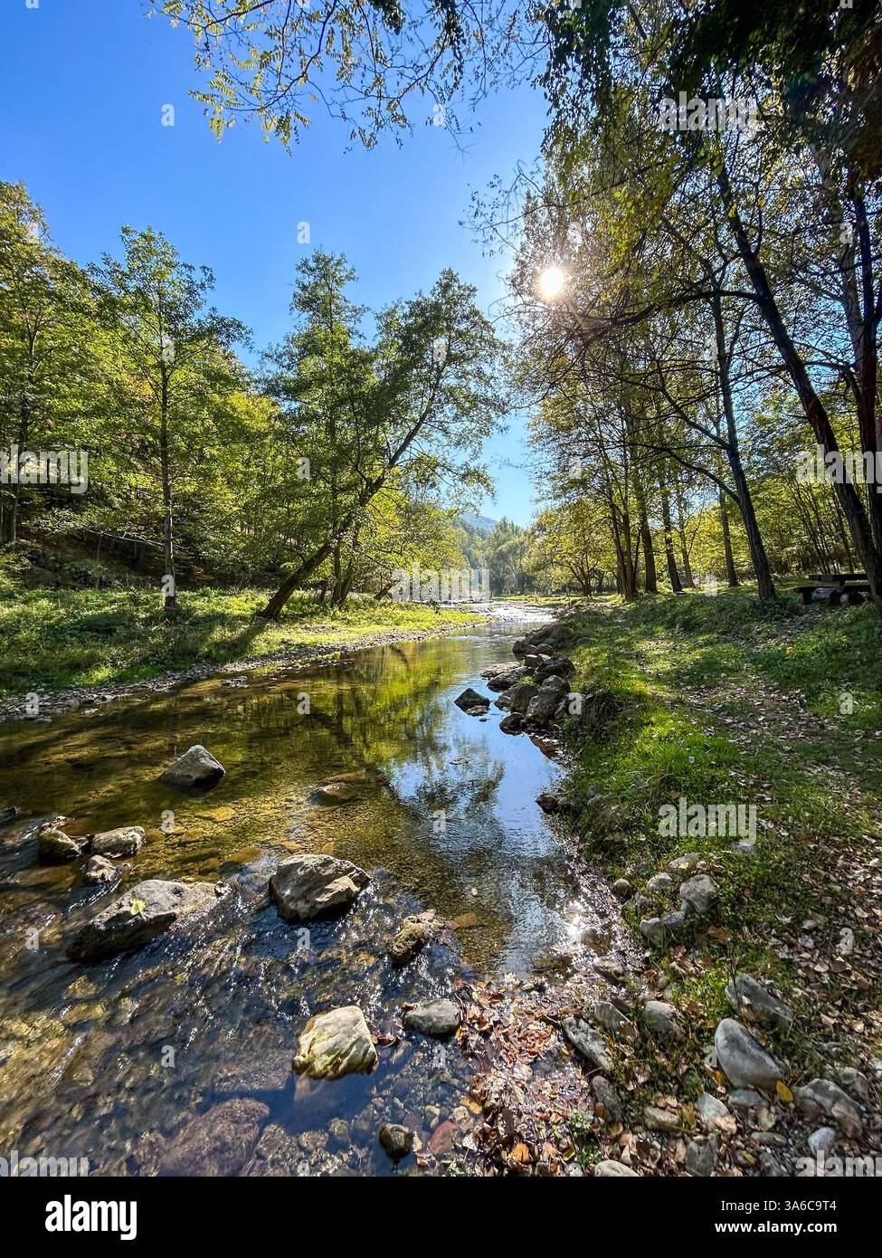 The Gradac River, known as the clearest river in Serbia, flows through untouched nature, with crystal-clear water and lush green surroundings. - Smartphone Captured Stock Image