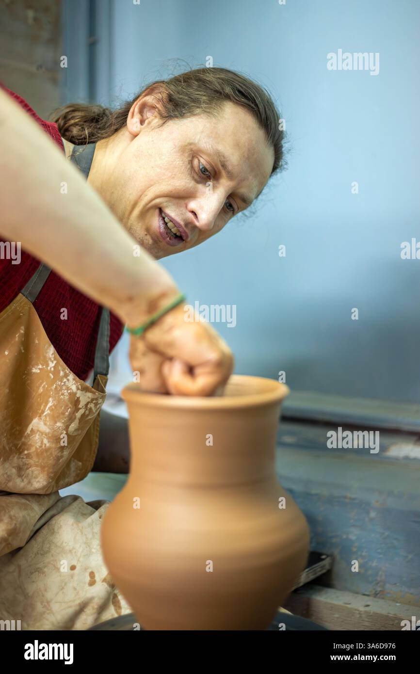 Master male potter making a vase. Pottery. Clay modeling. Creating ...