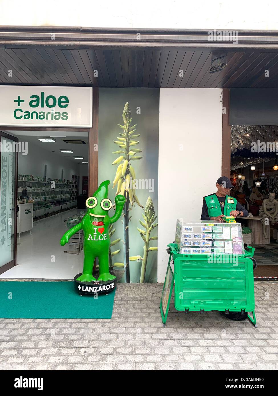 Tenerife tropical drink statue crates crate green door house with a balcony shop shops poster posters Canary Island Islands Spain man selling lottery - Smartphone Captured Stock Image