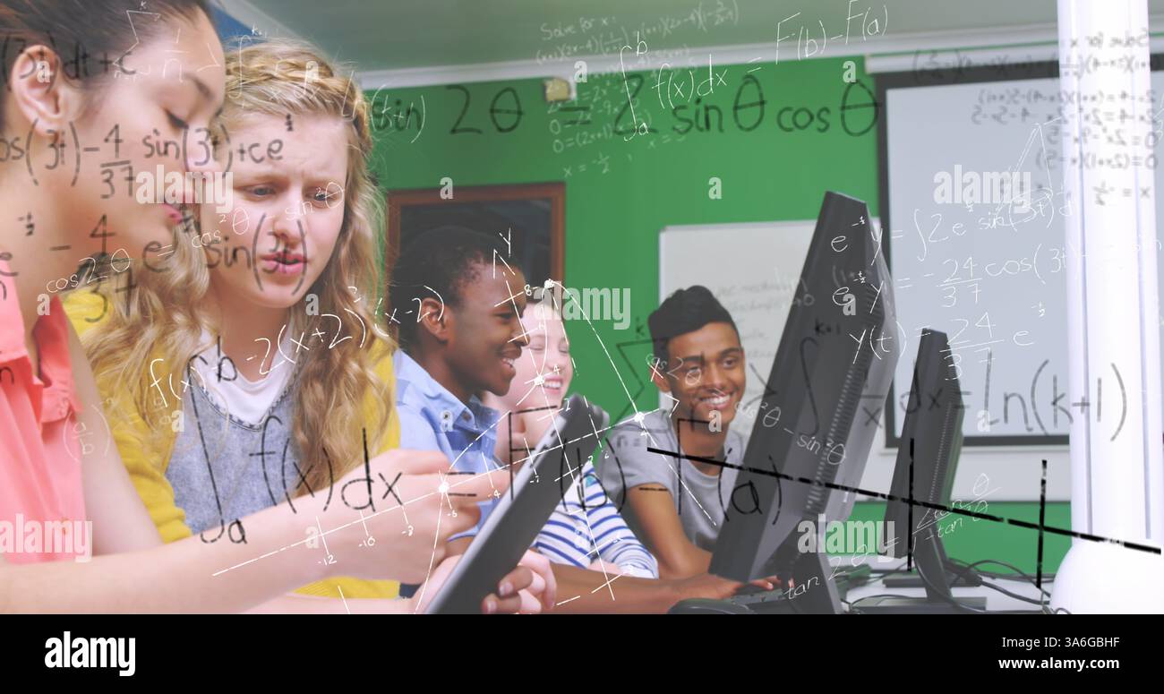 In school, students using computers collaborating on math project, staying engaged. Education, teamwork, collaboration, technology, learning, classroo Stock Photo