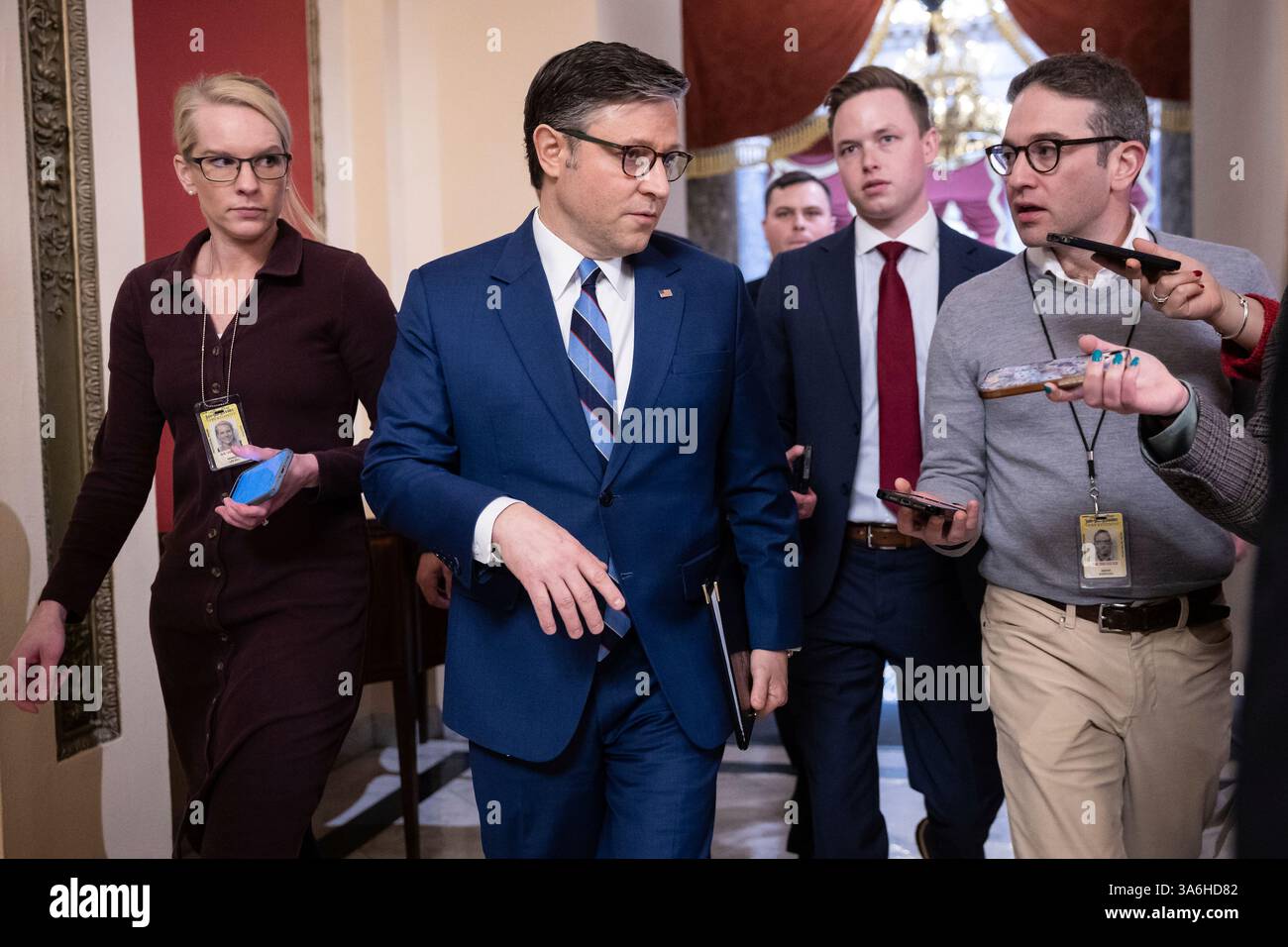 House Speaker Mike Johnson (R-La.) speaks with reporters as he walks to ...