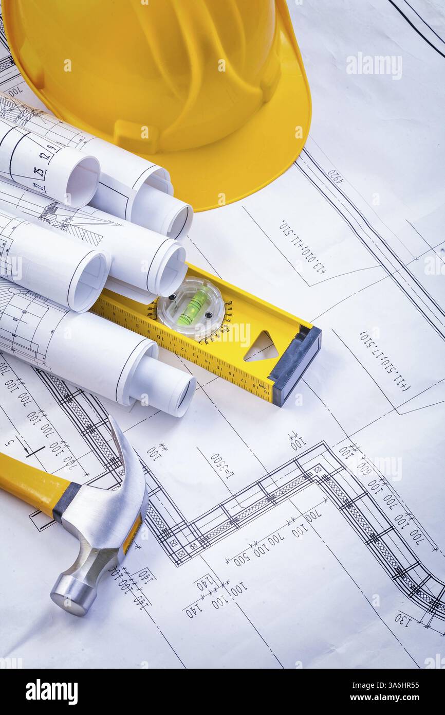 Composition of rolled blueprints claw hammer construction level helmet ...