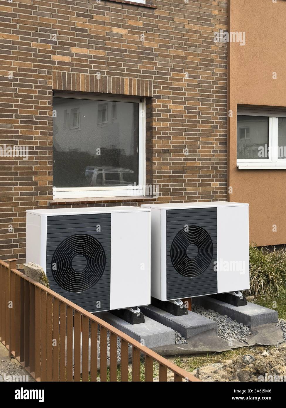 2 heat pumps are installed on an apartment block in a front garden ... - Heat Pump Systems In Scandinavian Apartment Renovation