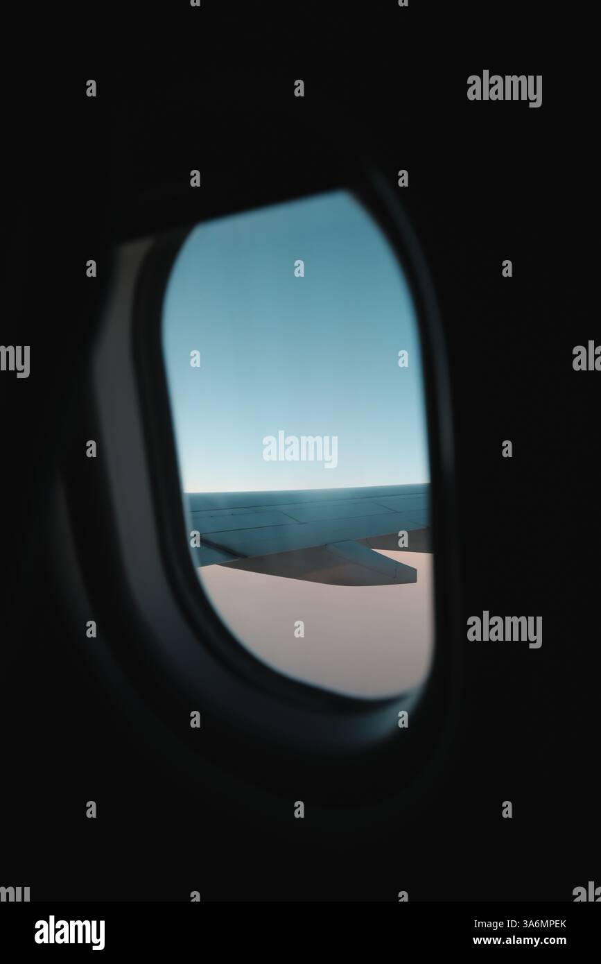 The incredible view from an airplane window showcases the wing and the ...