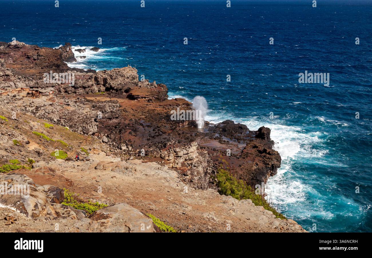 Nakalele Blowhole sprouting water on the cliffs in northern side of Maui. Witness the beauty of rugged coastline, waves crash against rocky cliffs Stock Photo