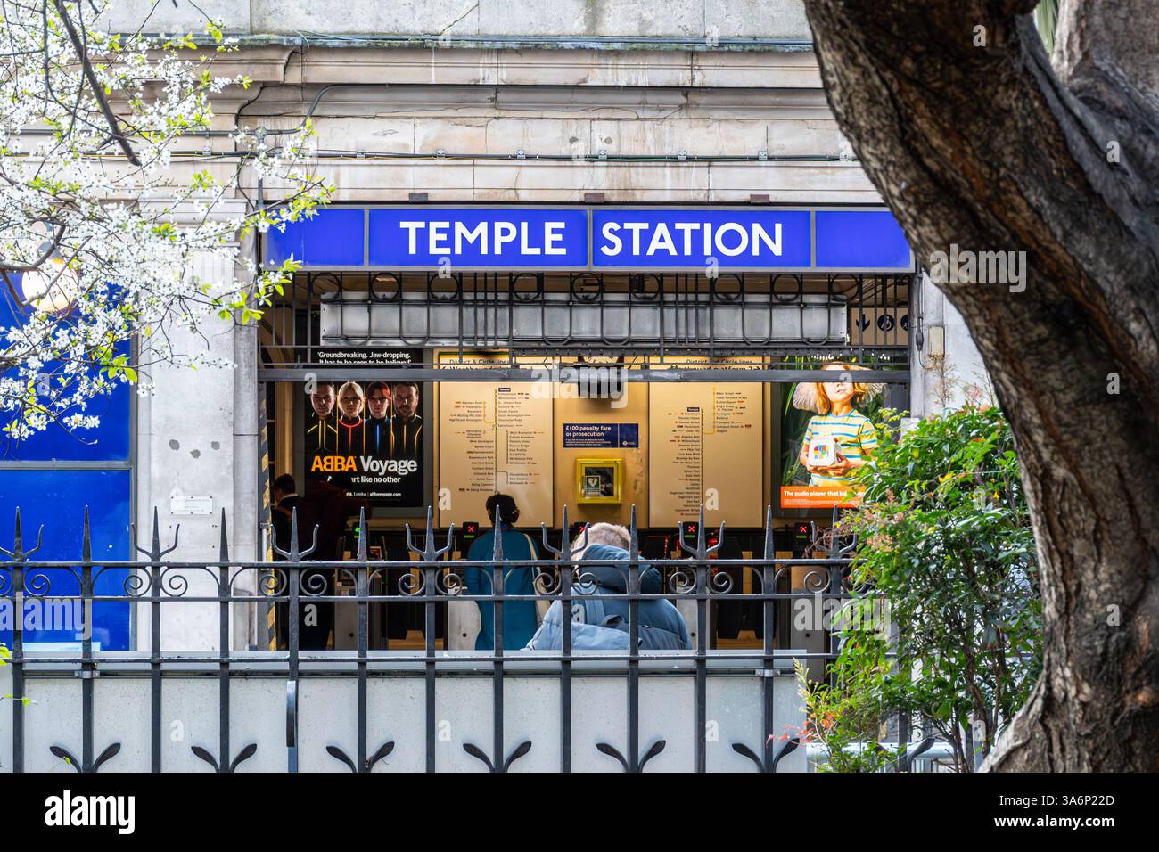 Passengers entering Temple Underground Station viewed from Victoria Embankment Gardens, London, England, UK Stock Photo