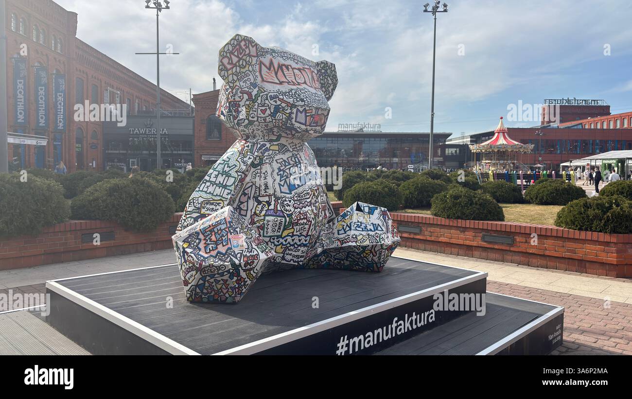 Monument of decorated teddy bear at Manufaktura shopping complex. City urban street view in Lodz, Poland. Architecture, buildings and shops Polish - Smartphone Captured Stock Image