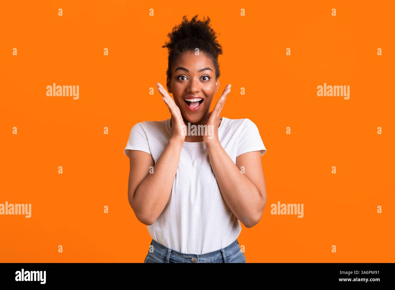 Happy afro woman screaming and holding cheeks Stock Photo - Alamy