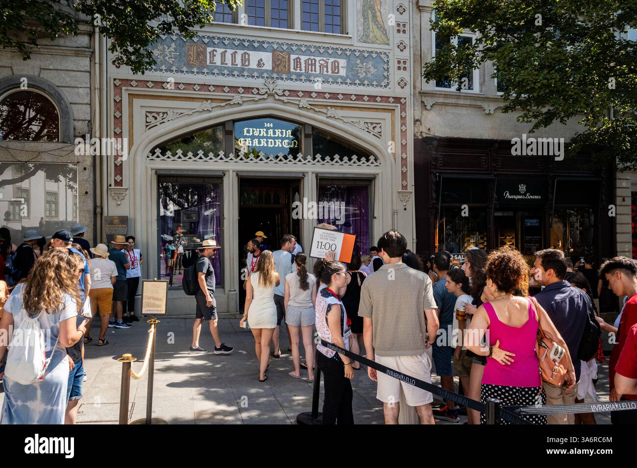 Porto, Portugal - July 30, 2024: Book lovers wait in line to go into Leibrello Livraria bookstore, a historic bookstore located in the city center. Stock Photo