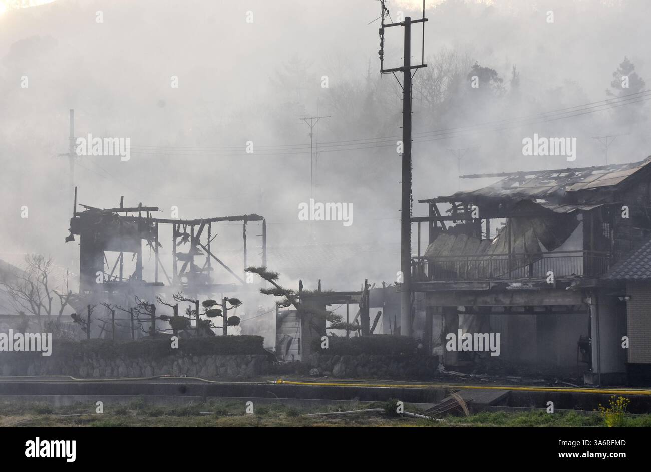 Residential houses burn down as a wildfire continues to rage in a ...