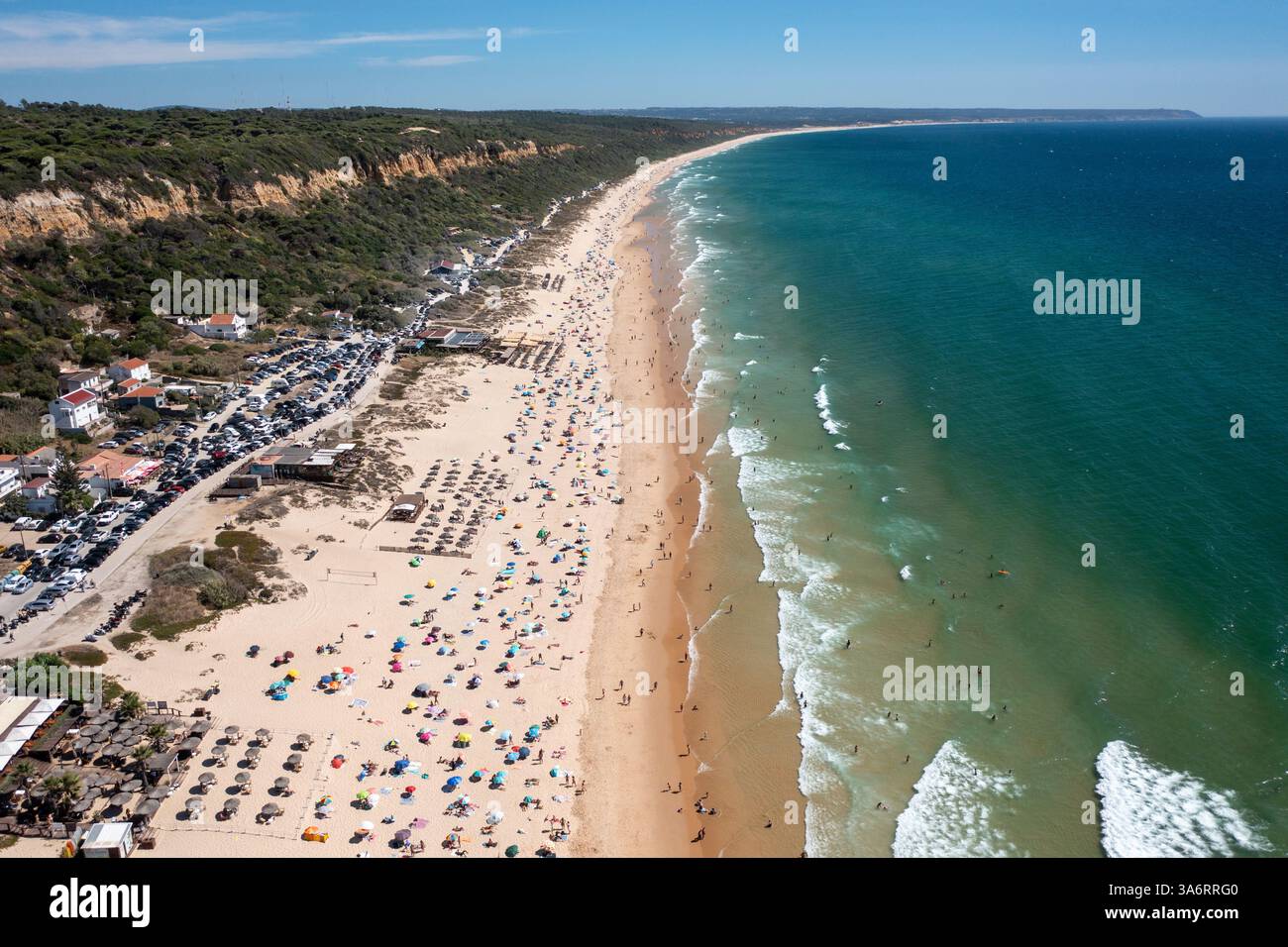 Aerial drone shot of Praia de Fonte da Telha beach in Costa de Caparica ...
