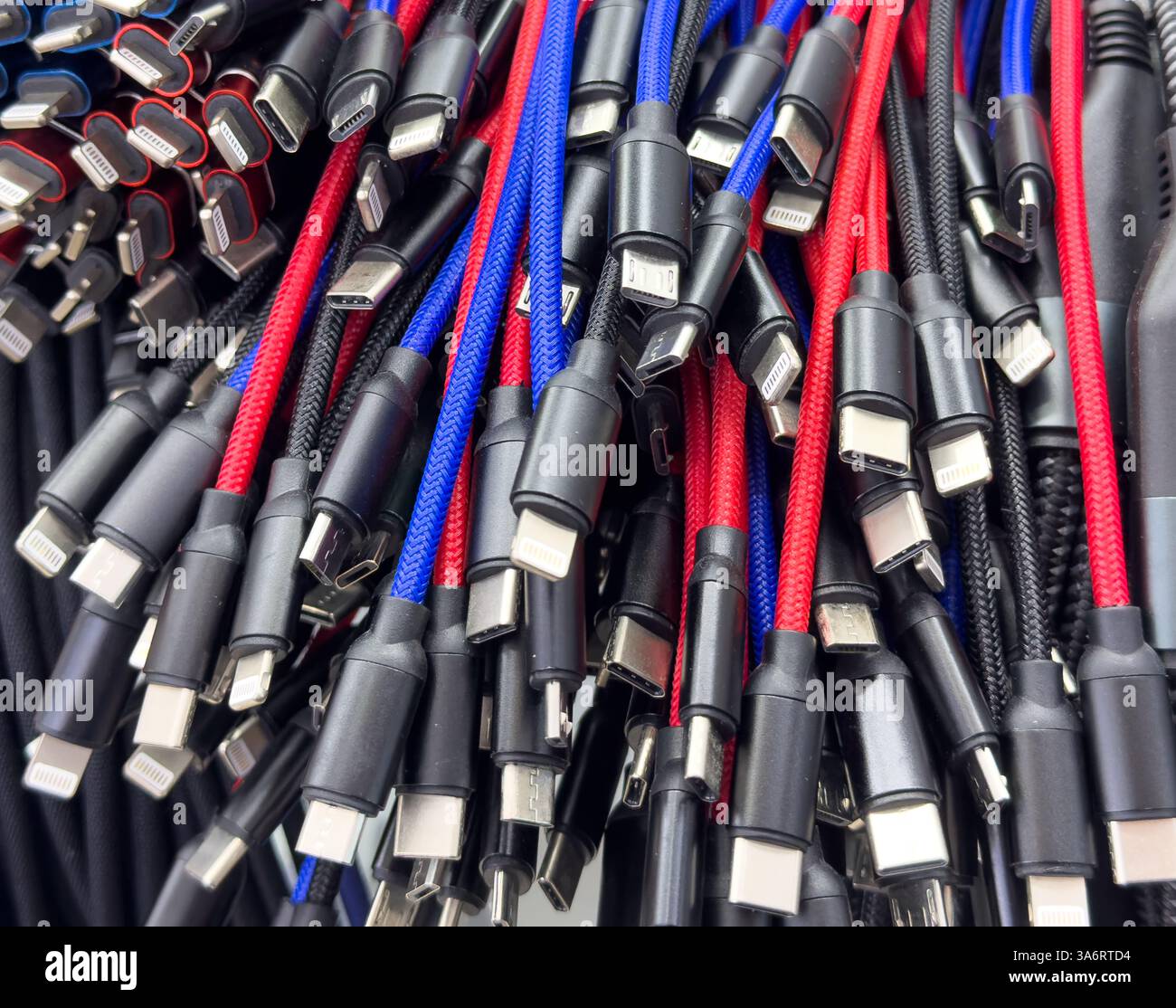 Different types of charger connectors for phones texture background. Charging or data cables. Stock Photo