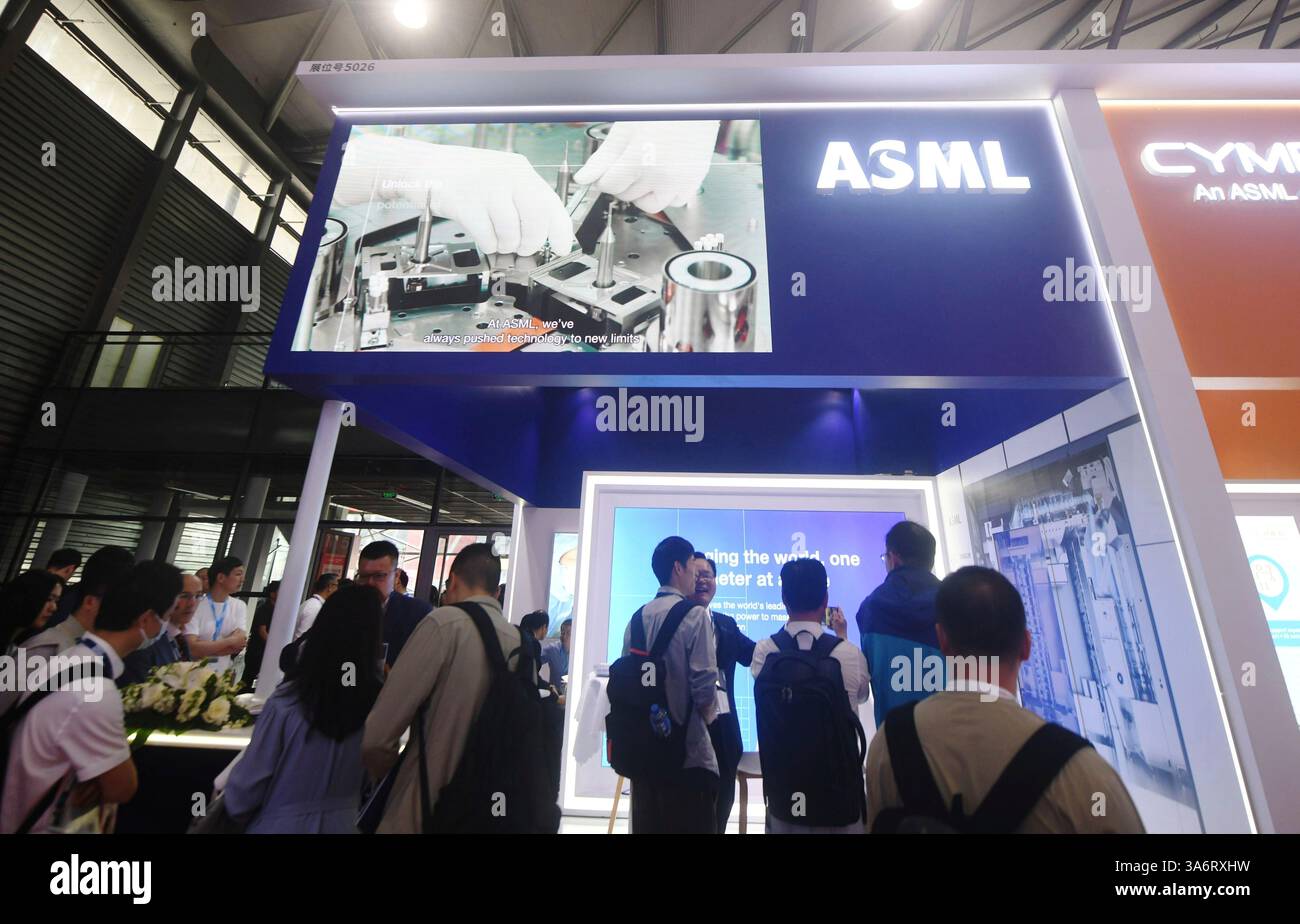 People visit the booth of ASML, a maker of semiconductor manufacturing ...