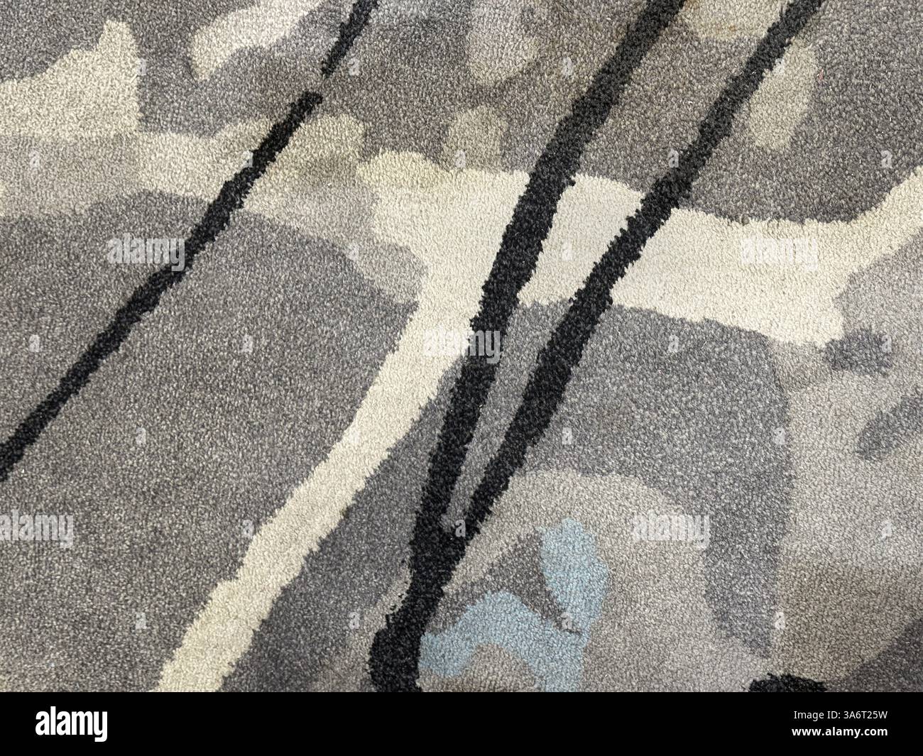 Random design with abstract pattern hand tufted carpet texture, in white, grey, and black color. Random abstract splashed, and random strokes pattern. Stock Photo