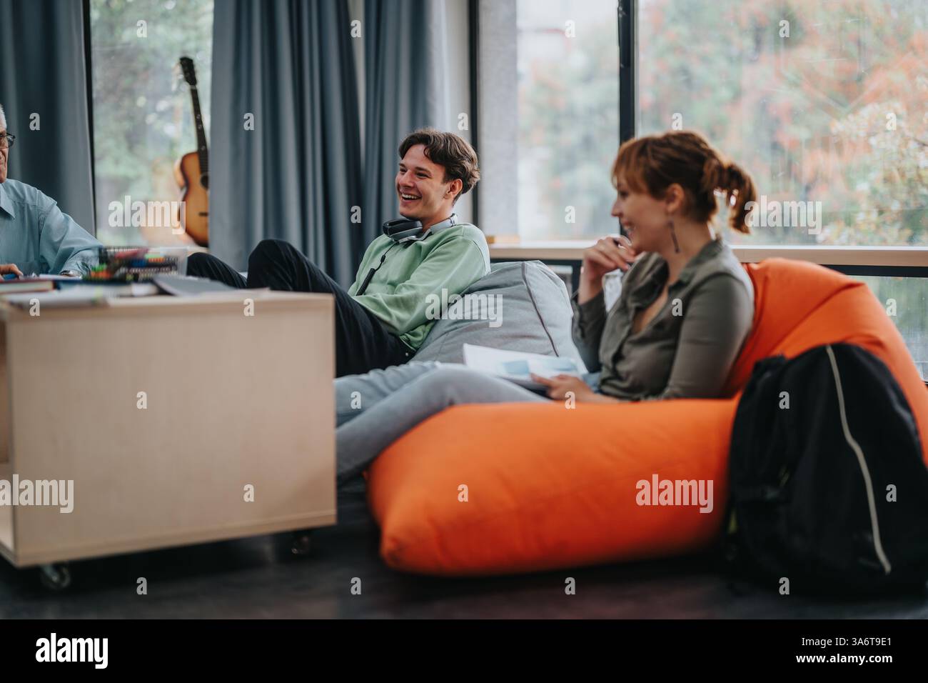 Professor engaging with students in a casual learning environment Stock Photo