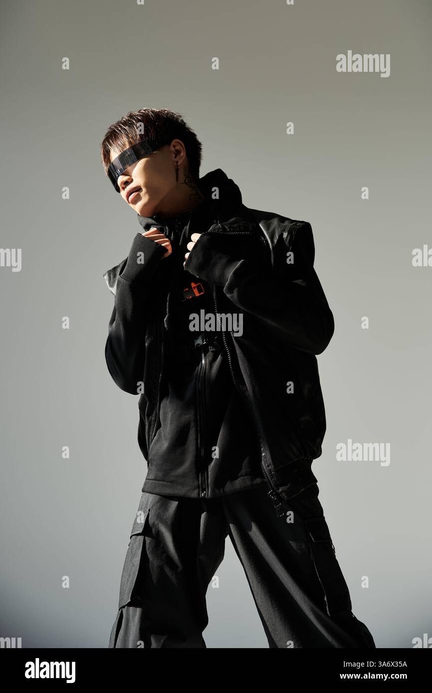 A stylish Asian man poses confidently in a sleek urban outfit Stock ...