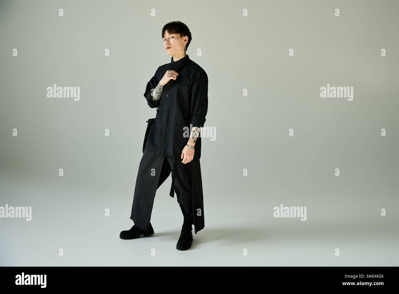 A handsome asian man poses confidently in trendy attire, showcasing ...