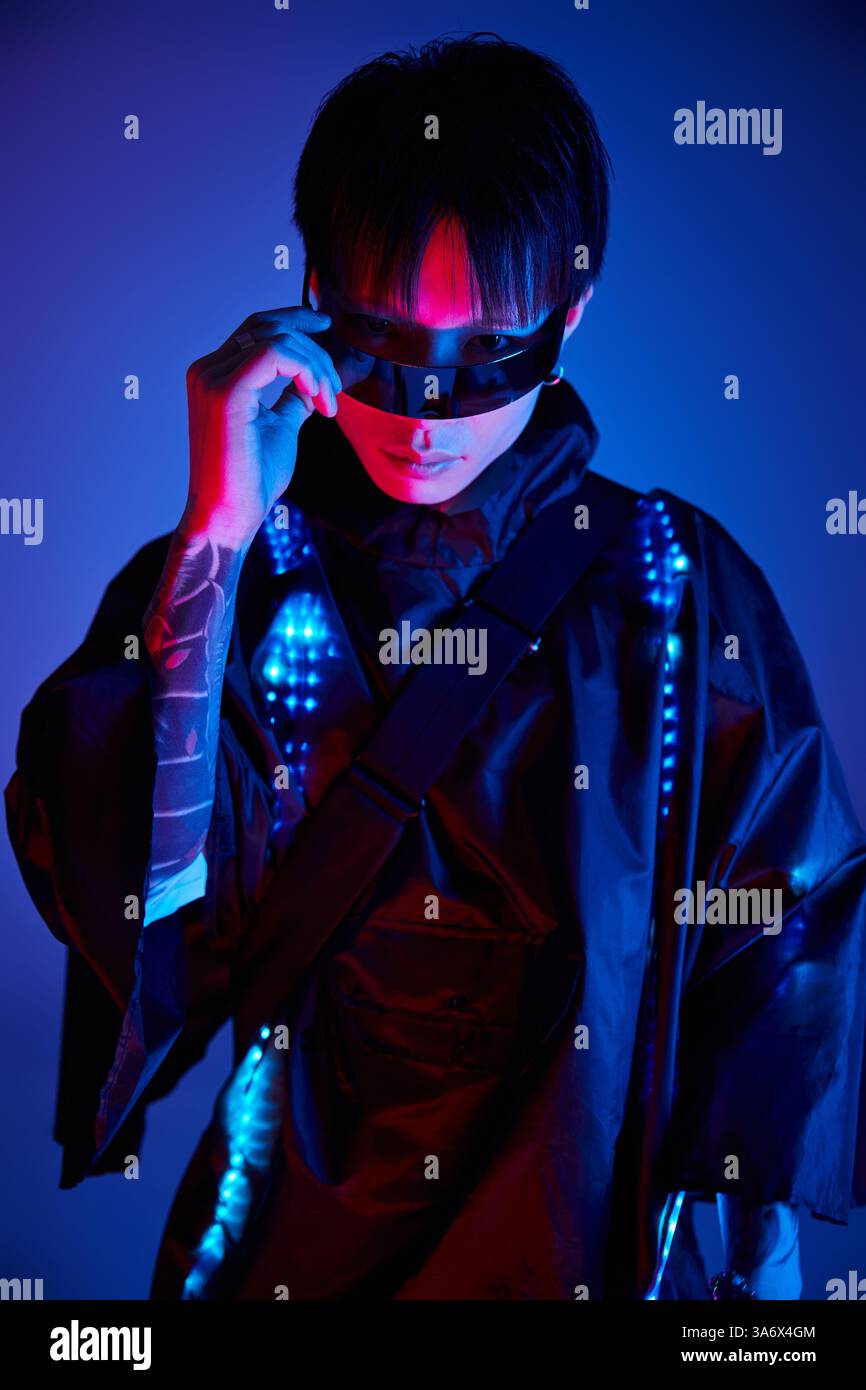 A fashionable young man poses confidently in sleek sunglasses under ...