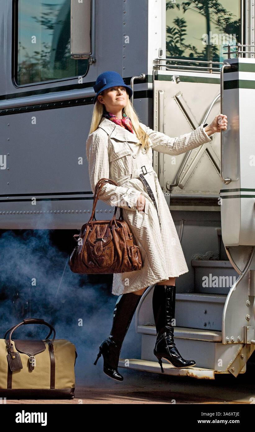 Nov. 12, 2008 - There's no stopping a travel-ready ensemble that starts with this Armani Collezioni trench in cream-colored faux patent crocodile fully lined in black and cream silk ($1,925, Neiman Marcus); a vibrantly patterned silk ''fantaisies indiennes'' scarf by Hermes ($375, Neiman Marcus); and Dolce & Gabbana's high-shine patent leather boots with a decorative heel and gold leather lining ($1,450, Neiman Marcus). Complementing the journey are Lockheart'ÃÆ’Ã‚Âs python ''Juliette'' satchel in cognac leather ($795, www.shopkikionline.com); a blue wool cloche hat from August Accessories ( Stock Photo