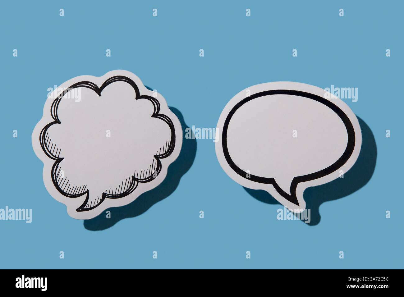 Two blank thought bubbles on blue background Stock Photo