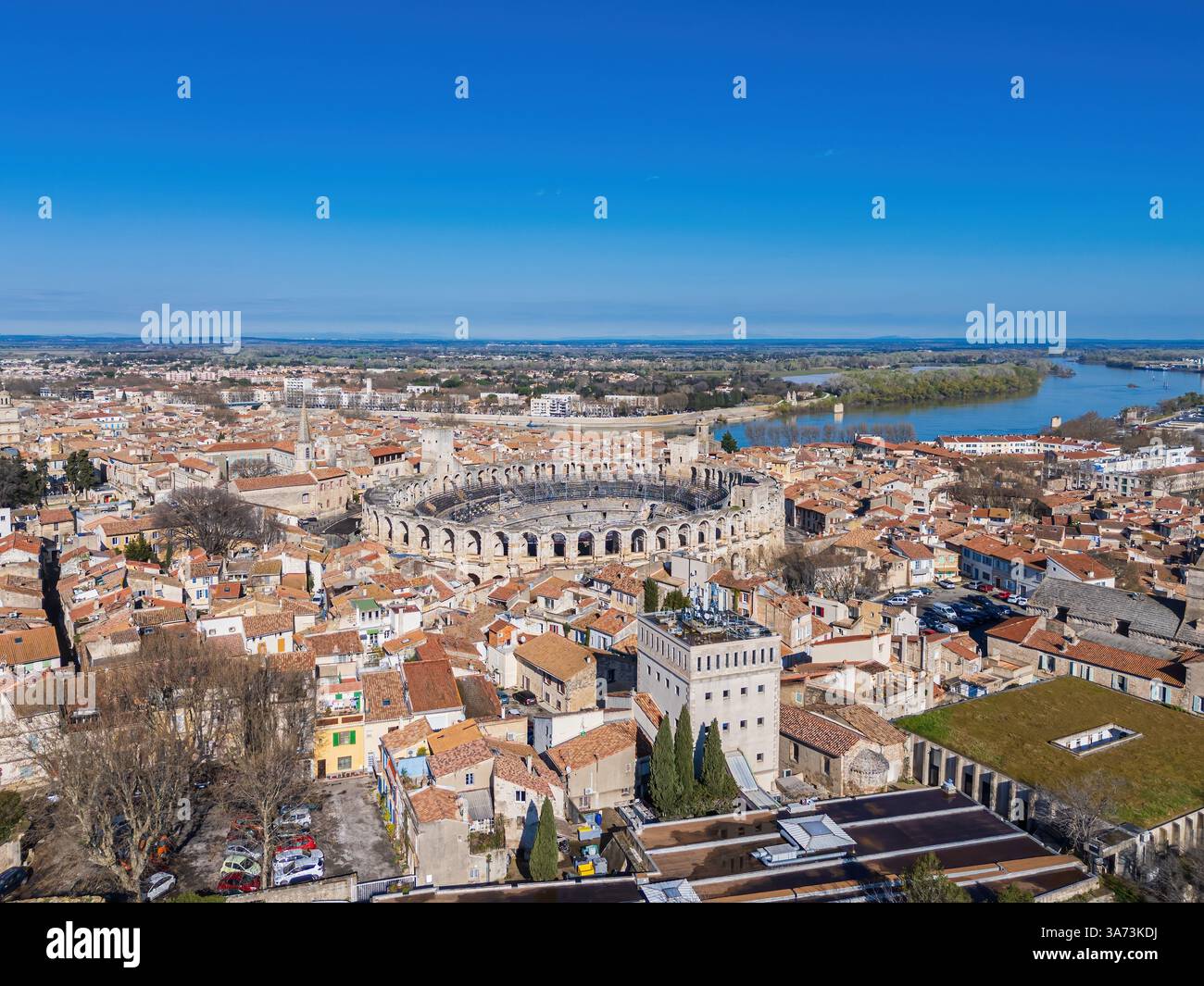 Cityscape of Arles with Amphitheatre and Rhone River visible from above ...