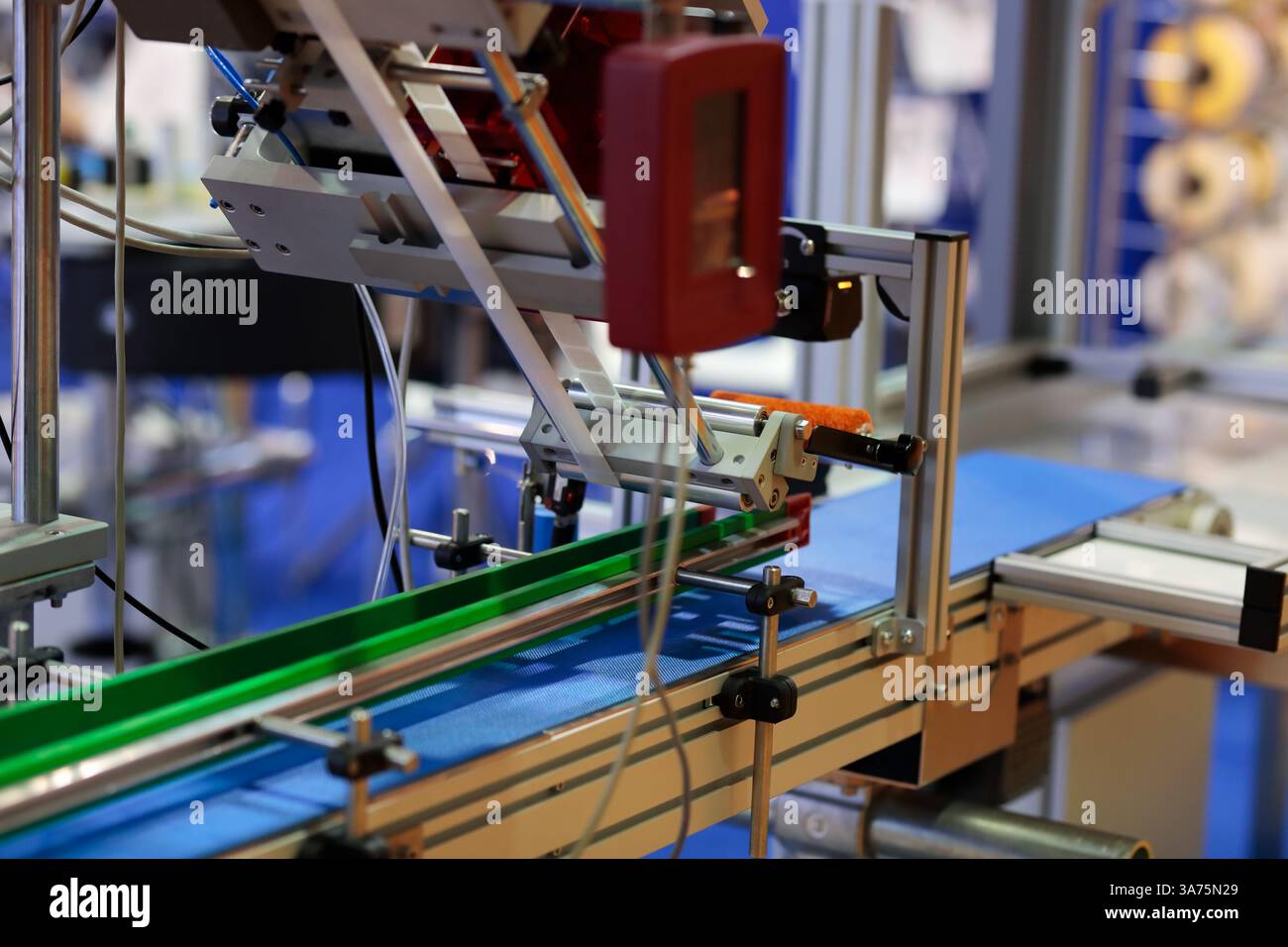 Conveyor line with automatic sticker labeling machine. Selective focus ...