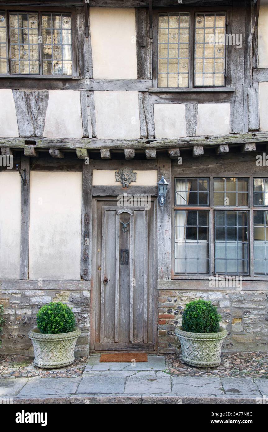 Abbey Cottage. This old weathered front door is part of a terrace of ancient Tudor cottages called the Pitchmarket in Cerne Abbas. Dorset, England, UK. Stock Photo