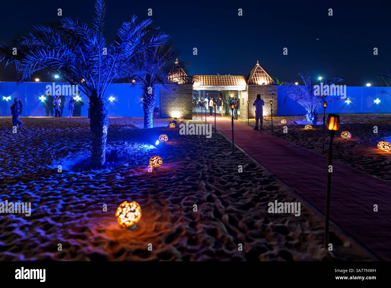 Exterior view of an illuminated desert safari camp and resort in the Sharjah Dubai desert, United Arab Emirates. Stock Photo